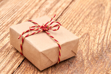 Christmas or New Year gift box on wooden surface. Close-up, selective focus