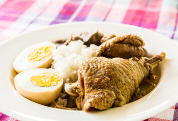 Thai  stewed chicken with rice and egg in plate , Thai famous street food.