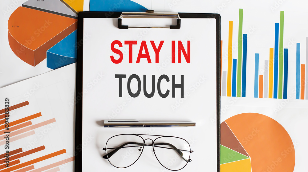 Aufkleber paper note with stay in touch message on chart. concept image