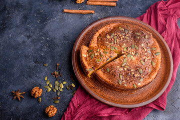 Pumpkin pie with lemon zest, pumpkin seeds, cinnamon, fragrant spices and spices on a dark background. Healthyfood