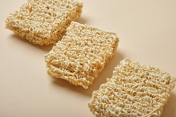 Dried instant noodles on beige background. close-up