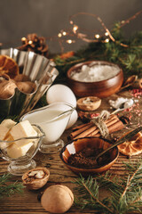 Ingredients for making a Christmas cupcake on the table, vertical photo