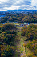 A distant view of the autumn leaves and mountains in the agricultural area in Japan