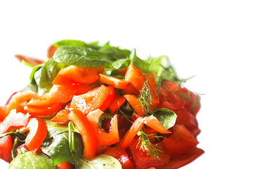 Fresh salad of the red tomatoes and spinach with salt and pepper
