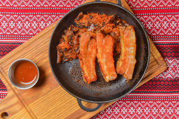 Delicious dinner and clean eating concept from above. Fried meat in a pan, on vintage background flat-lay.