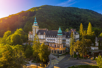 Lillafured, Hungary - Aerial view of the famous Lillafured Castle in the mountains of Bukk near Miskolc on a sunny summer morning. Rising sun with sunrays
