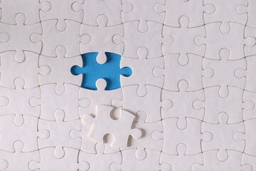 White puzzle pieces without one piece are on table closeup. Business strategy solution concept