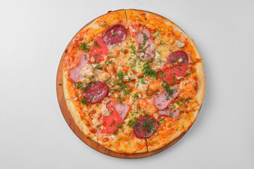 Pepperoni pizza on a white background. Traditional Italian pizza with tomatoes and meat isolated on white.