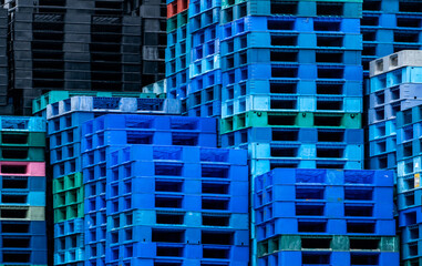 Pile of plastic shipping pallet. Industrial plastic pallet stacked at factory warehouse. Cargo and shipping concept. Plastic pallet rack for export delivery industry. Plastic pallet storage warehouse.