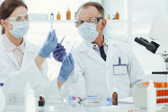 medical laboratory staff discussing the test results .