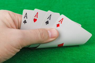 Hand with playing cards in casino