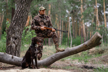 Concentrated 30s Man Hunting in Forest with Dog.