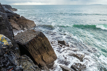 Rough stone coastline and Atlantic ocean water, West coast of Ireland, Cloudy sky