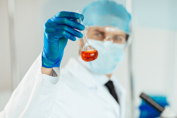close up. medical flask in the hands of the researcher.