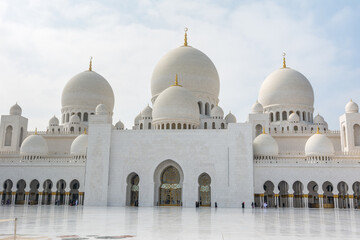 Domes of White Grand Mosque built with white marble stone, also called Sheikh Zayed Grand Mosque, inspired by Persian, Mughal and Moorish mosque architecture