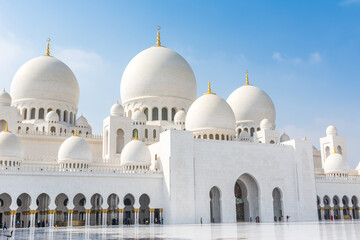 Fototapeta na wymiar Domes of White Grand Mosque built with white marble stone, also called Sheikh Zayed Grand Mosque, inspired by Persian, Mughal and Moorish mosque architecture