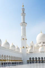 Foto op Plexiglas Minaret and domes of white Grand Mosque against white cloudy sky, also called Sheikh Zayed Grand Mosque, inspired by Persian, Mughal and Moorish mosque architecture © zz3701