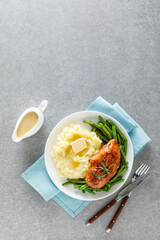 Roasted chicken breast with green beans and boiled mashed potatoes. Dinner or breakfast serving.
