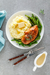Roasted chicken breast with green beans and boiled mashed potatoes. Dinner or breakfast serving.