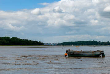 Boats stranded by low tide on the River Orwell at Pin Mill, Suffolk, UK