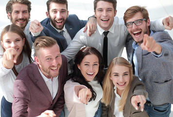 Fototapeta na wymiar happy team of successful young business people pointing at you