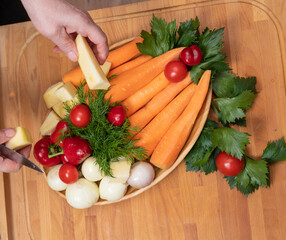 Woman preparing vegetable for salad in the kitchen