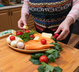 Woman preparing vegetable for salad in the kitchen