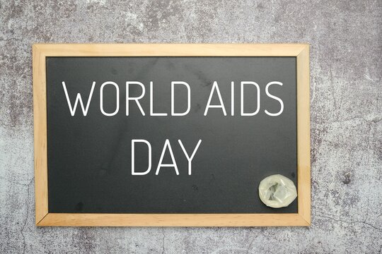 A picture of blackboard written World AIDS Day and condom insight.
