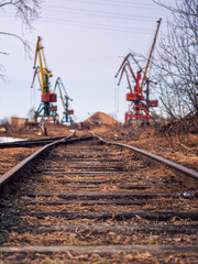 Fototapeta na wymiar Rail road tracks under the gantry cranes on the berth of sea merchant port