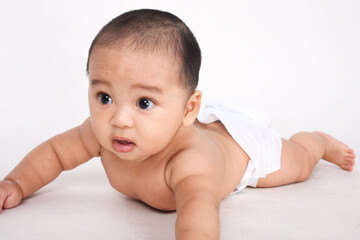 Cute Asian baby crawling and staring on white background