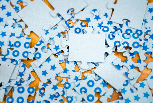 Close-up of blue puzzles of different sizes lying on the floor