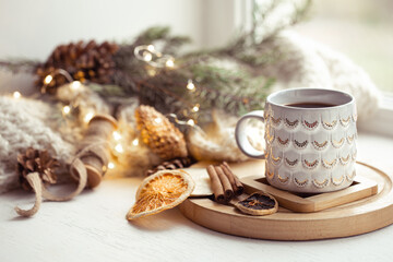 Beautiful cup with hot drink close up on blurred background with bokeh lights.