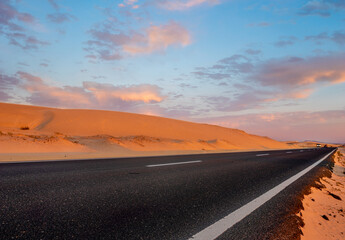 Obraz na płótnie Canvas scenic road that runs through the sand dunes of Fuerteventura