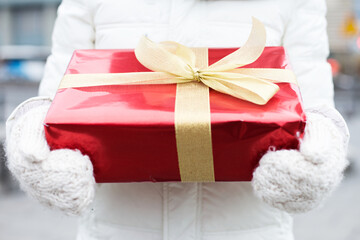 Midsection of woman holding gift box winter