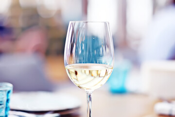 glass of white wine in the restaurant / white wine in the interior of the restaurant a table with glasses of wine, a romantic summer