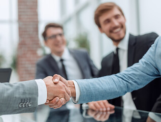 business handshake on the background of applauding business team