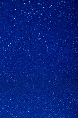 Abstract blue blurred sparkling background with focused area. Holiday festive concept. Glitter confetti. Christmas lights. Vertical image