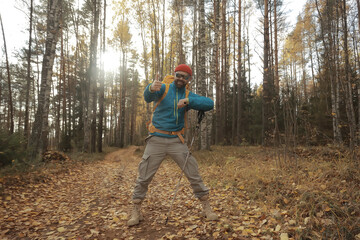 follow me on a hike, a man invites you to a forest hike, autumn landscape in the forest in nature