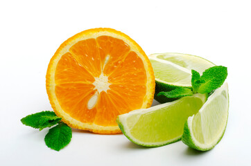 Closeup of sweet cutted orange, lime wedges, green fresh mint leaves on the white background