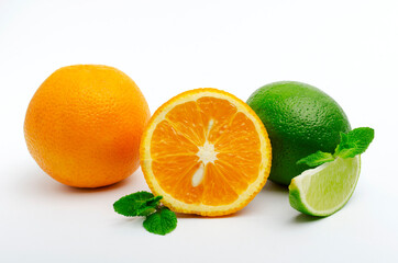 Whole orange, cutted one, lime wedge and whole one, mint leaves on the white background