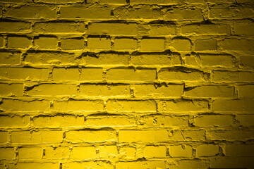 Background of empty brick wall with yellow neon light.