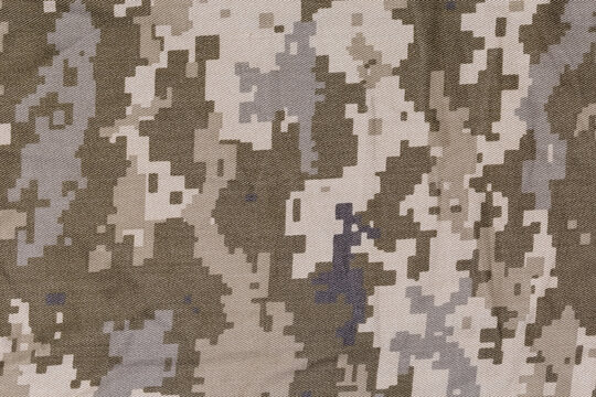 Slightly crumpled fabric with digital camouflage pattern close-up, background
