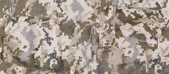 Fragment of pants of digital camouflage fabric with different pockets