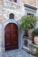 Antique  door with a brick arch layout at Civita di Bagnoregio,Italy. Is one of the most beautiful and characteristic Italian villages .