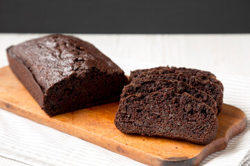 Homemade Chocolate Zucchini Bread on a rustic wooden board, side view. Close-up.
