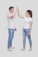 Fototapeta premium Young Couple Making High Five Standing Isolated