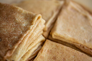 A stack of homemade pancakes on a plate. Traditional Russian pastries.