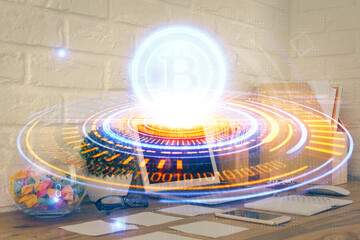Multi exposure of blockchain and crypto economy theme hologram and table with computer background. Concept of bitcoin cryptocurrency.