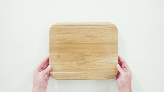 Flat lay. Step by step. Empty wooden cutting board with a kitchen knife.