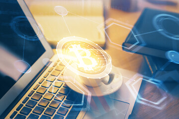 Multi exposure of blockchain and crypto economy theme hologram and table with computer background....